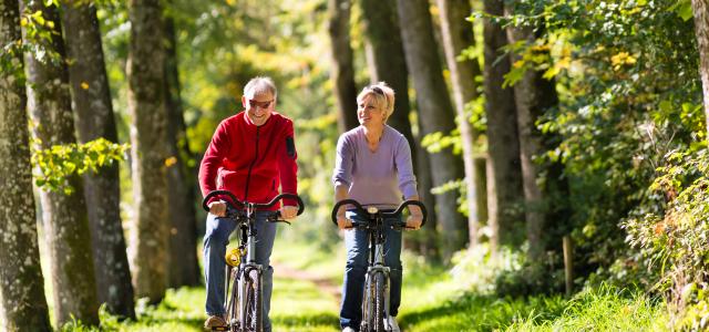 couple bike riding in forest